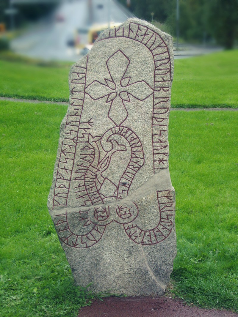 Rune stone, Sweden. With traditional gärdesgård fence in the